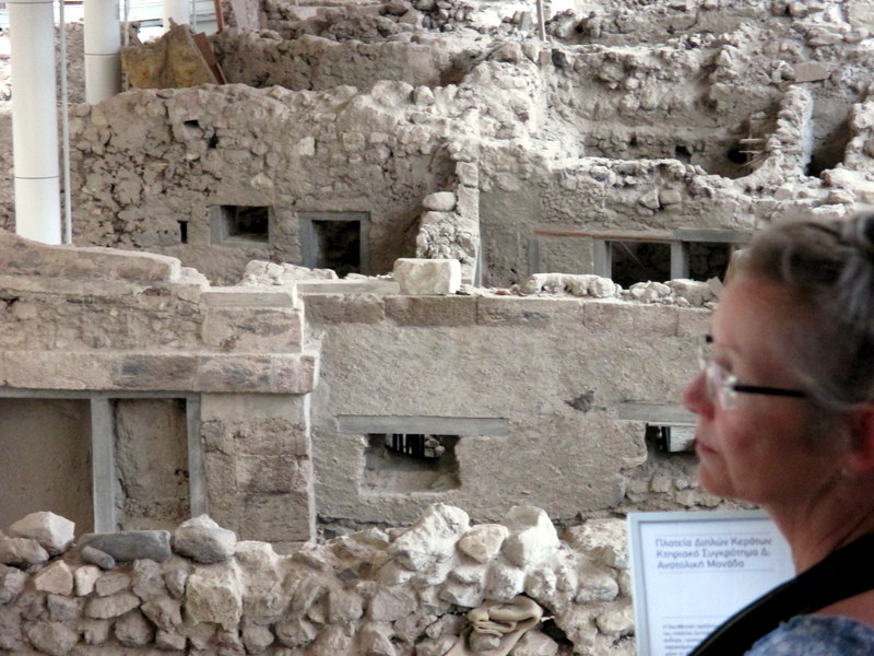 Elaine with the walls of houses at Akrotiri